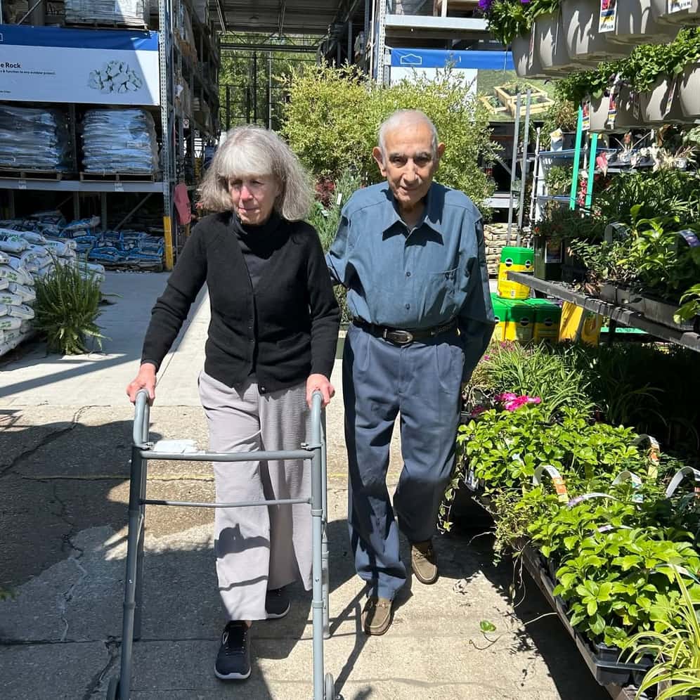 Two residents browse the garden center on a community outing to a local nursery, organized by Traditions at North Willow.